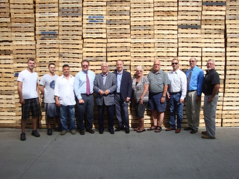 Group in front of Large tower of Pallets